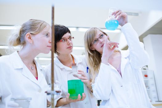 portrait of a female researcher carrying out research in a chemistry lab (color toned image; shallow DOF)