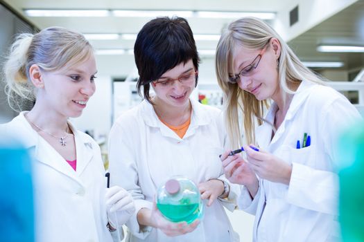 portrait of a female researcher carrying out research in a chemistry lab (color toned image; shallow DOF)