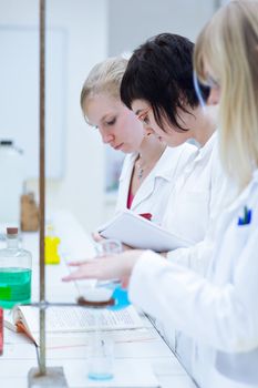 portrait of a female researcher carrying out research in a chemistry lab (color toned image; shallow DOF)