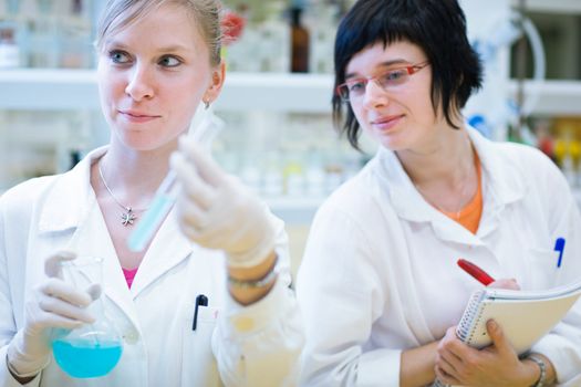 portrait of a female researcher carrying out research in a chemistry lab (color toned image; shallow DOF)