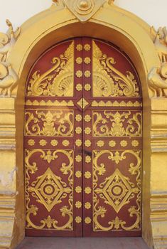 Buddhist temple door decoration in the capital of Vientiane, Laos