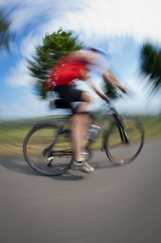 Cycling series: biker cycling outdoors (fisheye lens distortion and motion blur are used to convey dynamic movement)