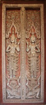 Delicate and elaborated detailed of the Buddhist monastery window, Laos