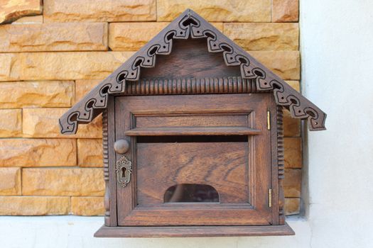Wood mailbox or letter box on brick house