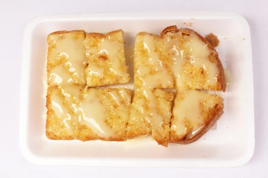 Toast bread with butter and sweetened condensed milk on foam plate