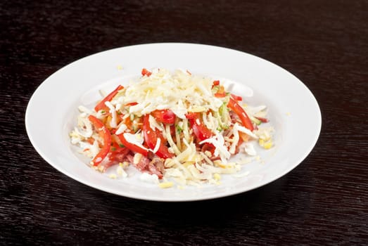 Salad from beef tongue, cervelat, chicken meat, fresh tomatoes, cucumbers, pepper, eggs, cheese and mayonnaise