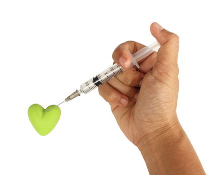 Hand holding a hypodermic syringe being inject into heart