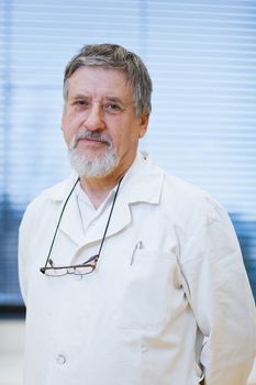 senior male researcher carrying out scientific research in a lab (shallow DOF; color toned image)