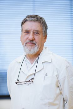 senior male researcher carrying out scientific research in a lab (shallow DOF; color toned image)