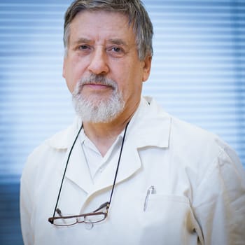 senior male researcher carrying out scientific research in a lab (shallow DOF; color toned image)