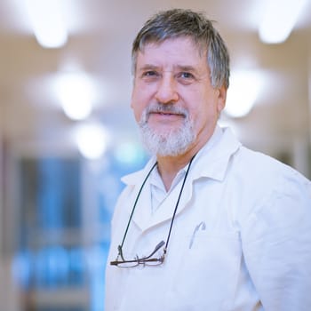 senior male researcher carrying out scientific research in a lab (shallow DOF; color toned image)