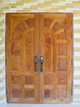 King of Nagas design on brown door of house