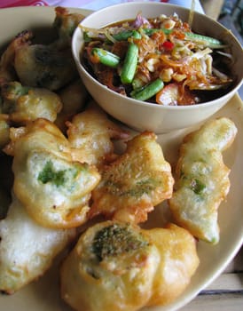 Crisp deep fried vegetables with spicy salad on dish