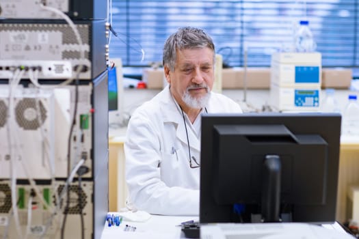 senior male researcher carrying out scientific research in a lab (shallow DOF; color toned image)