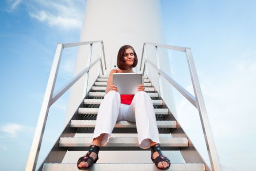 Tablet computer concept: pretty young woman using a tablet computer