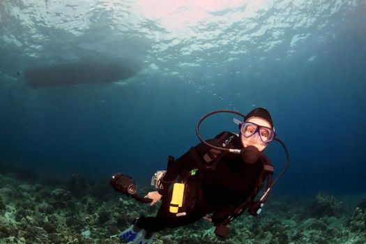 Scuba Diver swimming under the boat