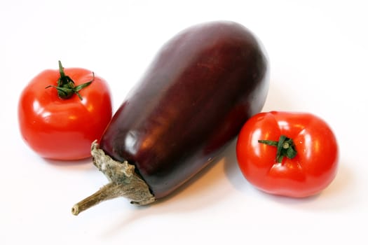 eggplant and tomatoes at the white background