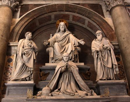 A sculpture in St. Peter's basilica featuring Jesus, Saint Paul, Saint Peter and a pope.