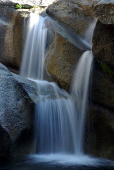 A waterfall in summertime located in the Crystal Basin Wilderness area in California.