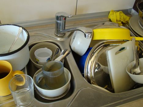 Mess in kitchen sink before wash