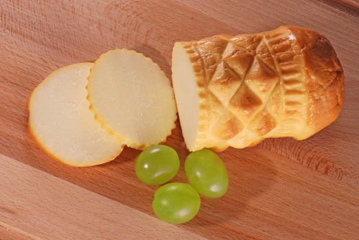 Traditional Polish cheese known as oscypek on a wooden board