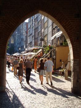 Tourists in old gateway in old town in Gdansk