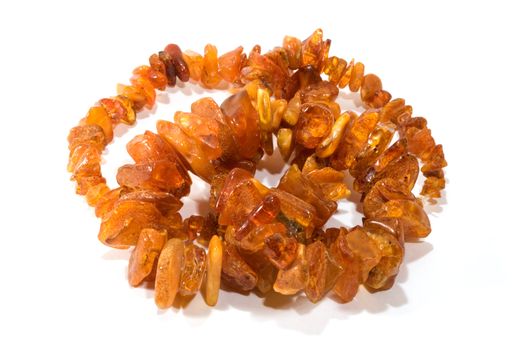 thread of amber bead on white background. close-up.