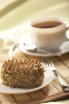 light still life: cup of tea and nut cake