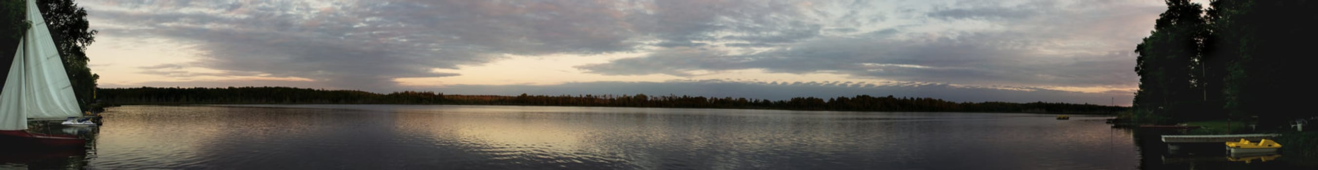 Large multiple photo panoramic picture of a lake at dusk
