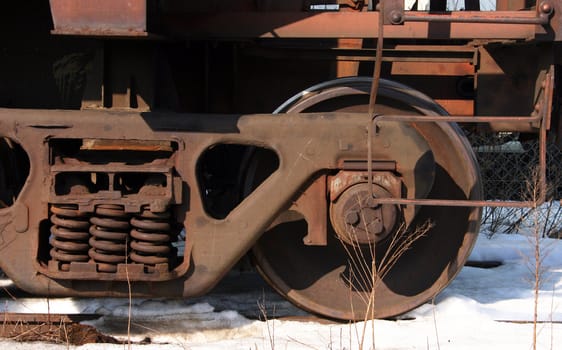 Old rusted freight train wheel sitting on the tracks