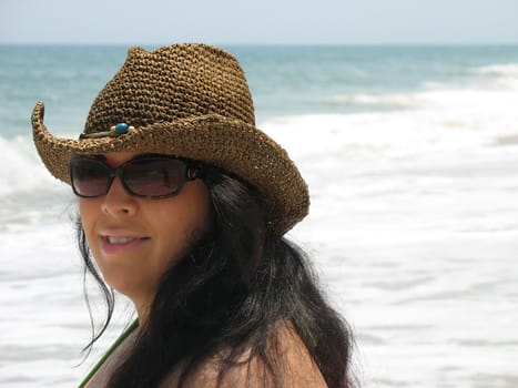 A pretty Spanish model smiling at the beach - Assateague Island, located near Ocean City, Maryland.  Plenty of copy space.