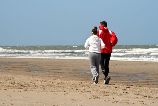 Man and woman running on the beach