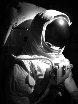 A complete astronaut setup under dramatic lighting.  Black and white.