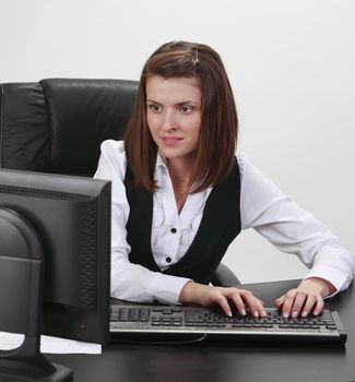 Young businesswoman at her desk working on the computer