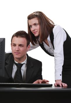 Young couple looking together to a computer, isolated against a white background.