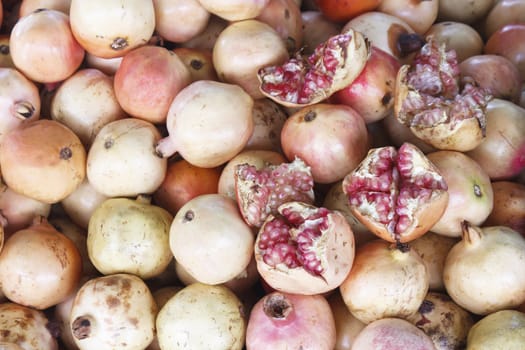 Ripe pomegranates (Punica granatum) fruit on sale at fruit market