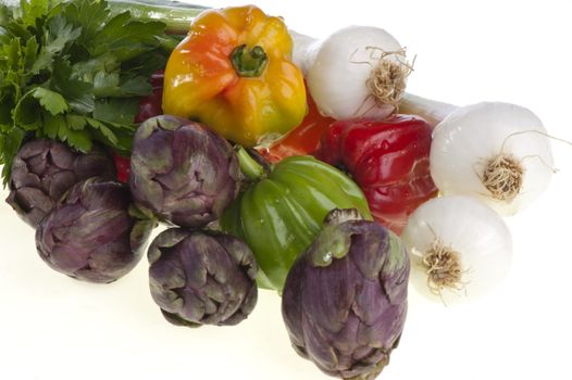 small exotic peppers and artichokes on a white background