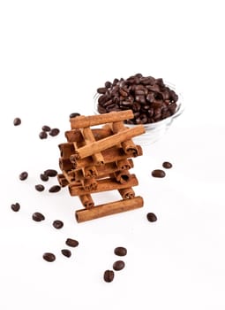 cinnamon sticks and coffee beans on white