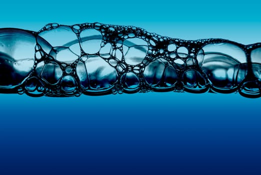 Water with bubbles on blue background.