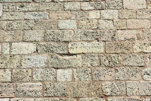 Ancient weathered brick wall close up background