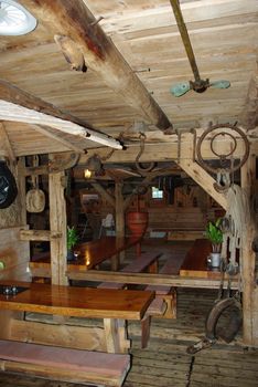 Old village tavern. Rural interior of table with cups and other utencils.