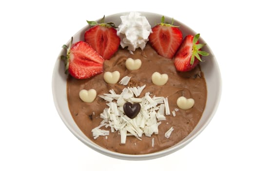Picture of a dessert with strawberries, chocolate hearts and some cream