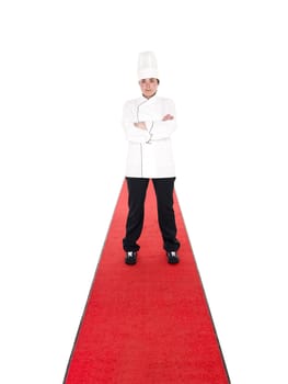 Serious chef on a red carpet isolated on white background