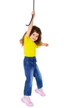 Cheerful little girl hanging on a rope isolated on white background