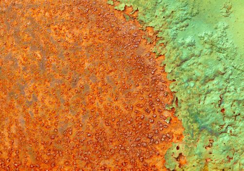 Partially rotted paint on the metal rusty surface