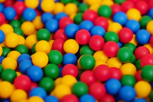 A large number of toy balls of different color - the background