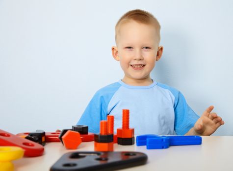 A happy child playing with toy instruments