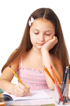 Cute little girl sketching something in the copybook