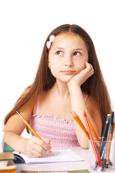 Cute little girl sketching something, holding her hand under her chin, looking away.