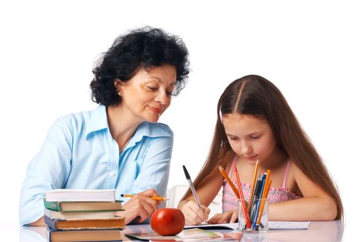 Grandmother helping her granddaughter with her home-work, holding hand under chin.Grandmother helping her granddaughter with her home-work, holding hand under chin.